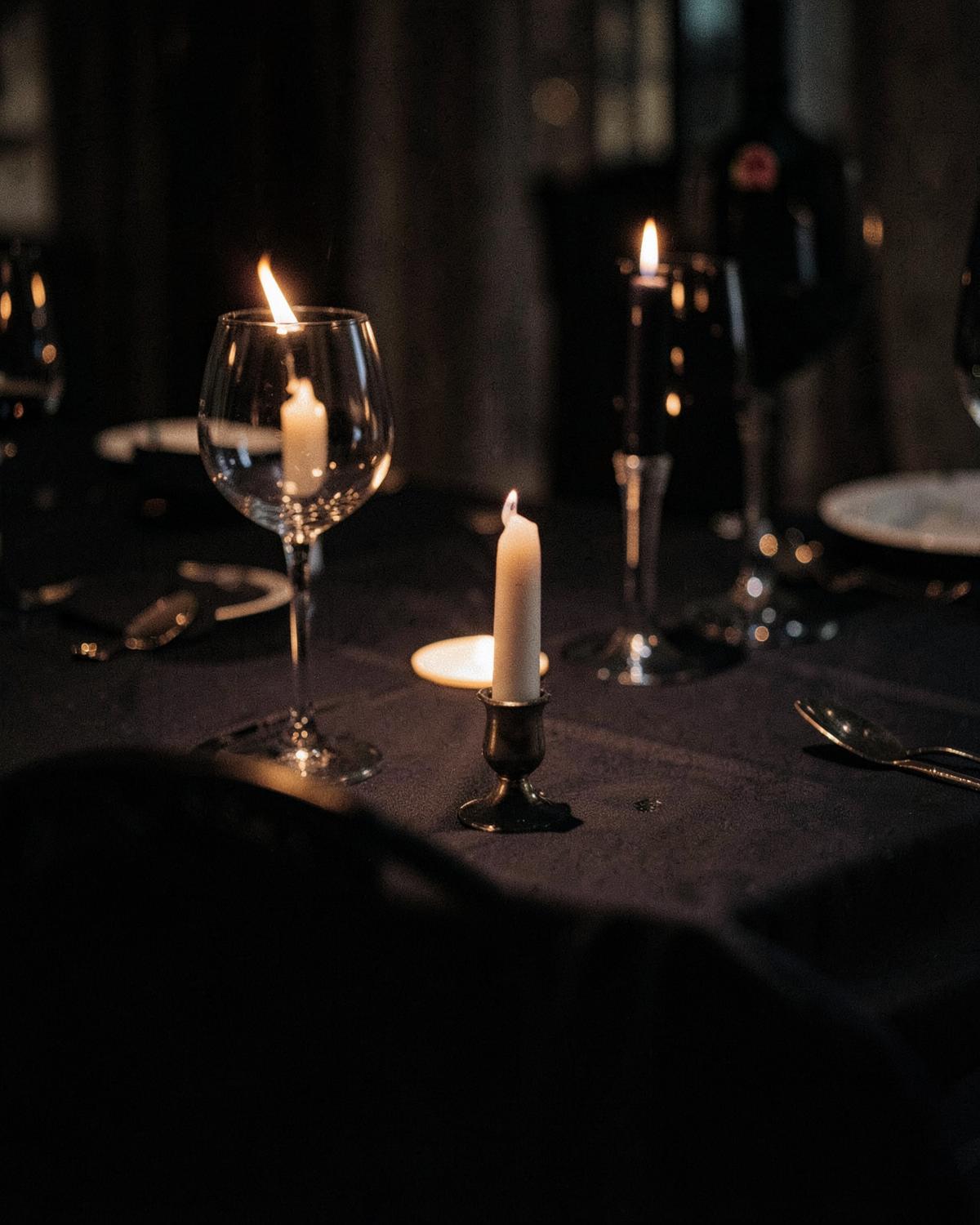 Candlelit table setting in low warm light