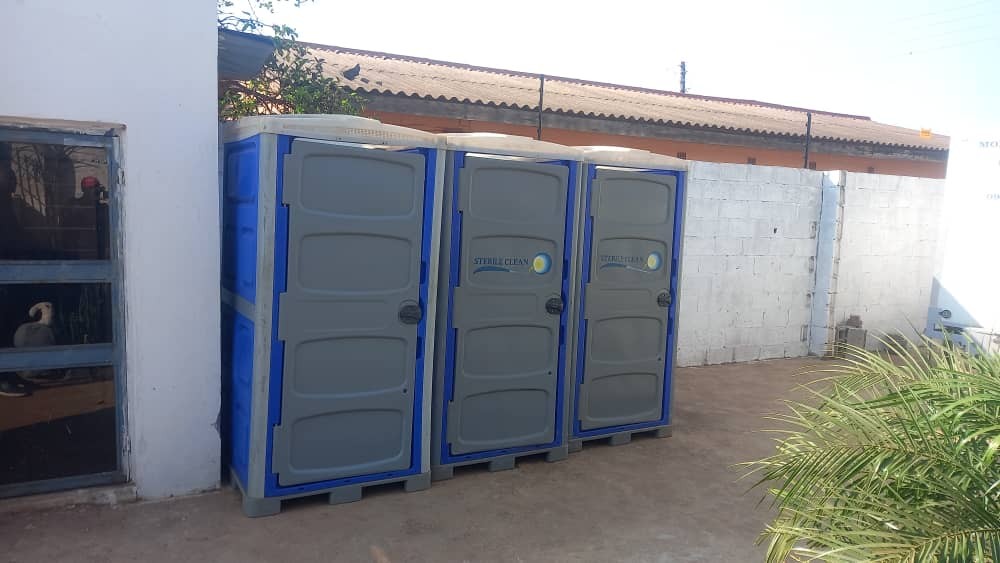 Three portable toilet units installed on site in Ndola